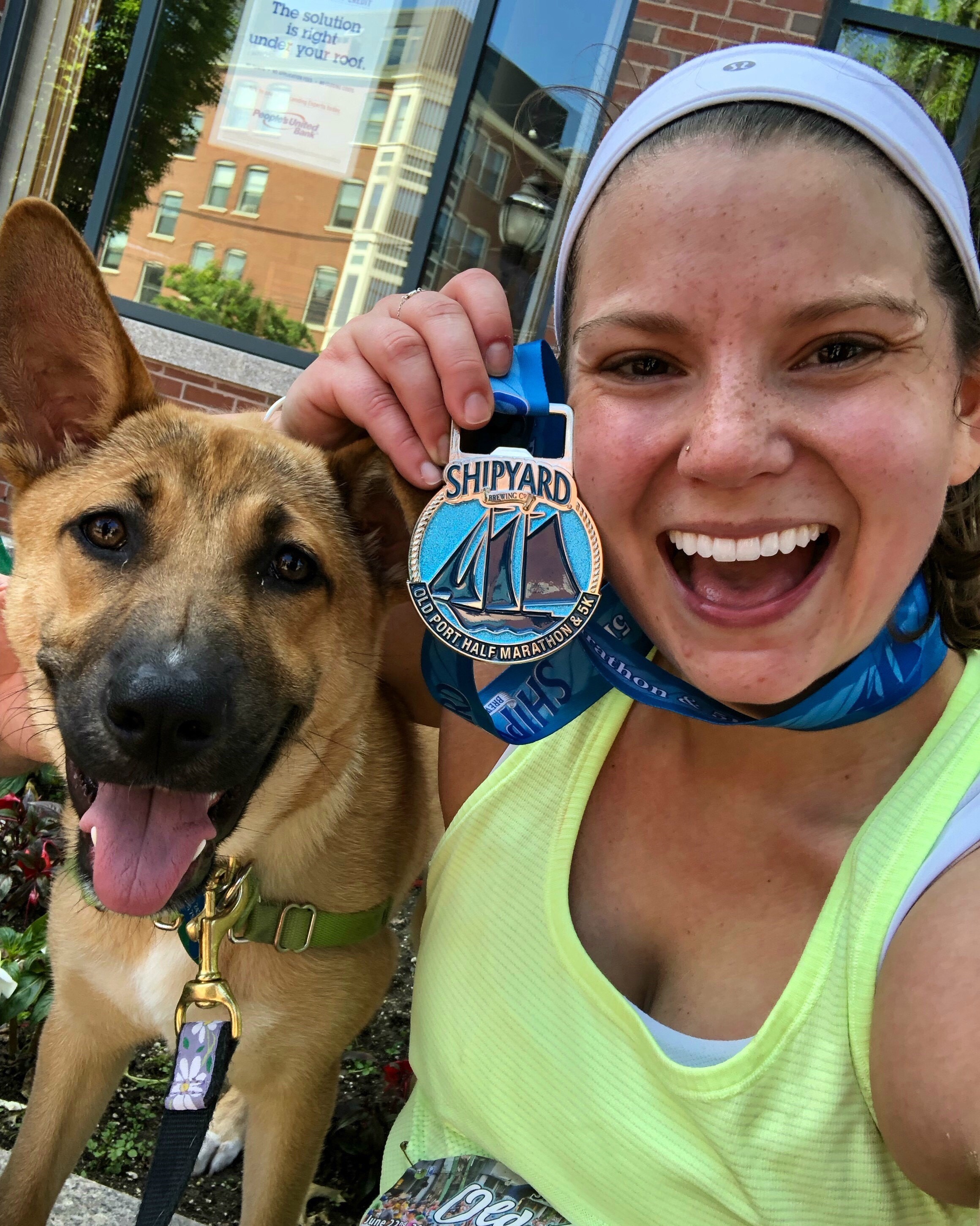 Angelica with her half-marathon medal and her puppy